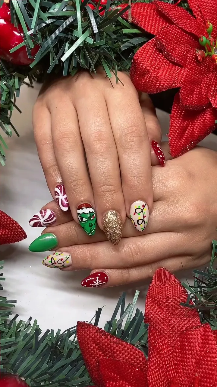 Grinch candy cane snowflake almond nails on a poinsettia wreath
