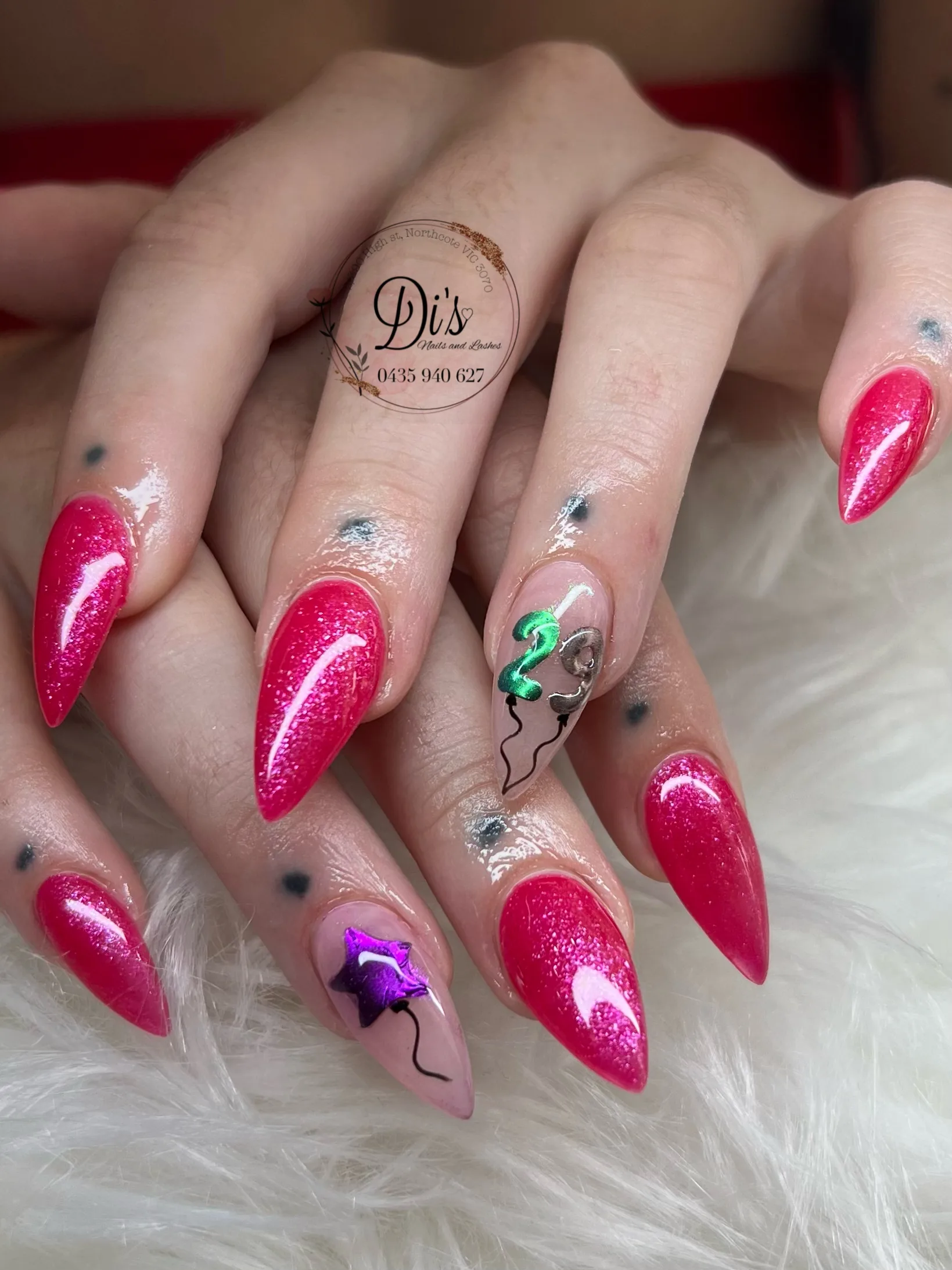 Magenta stiletto nails with foil birthday balloon art