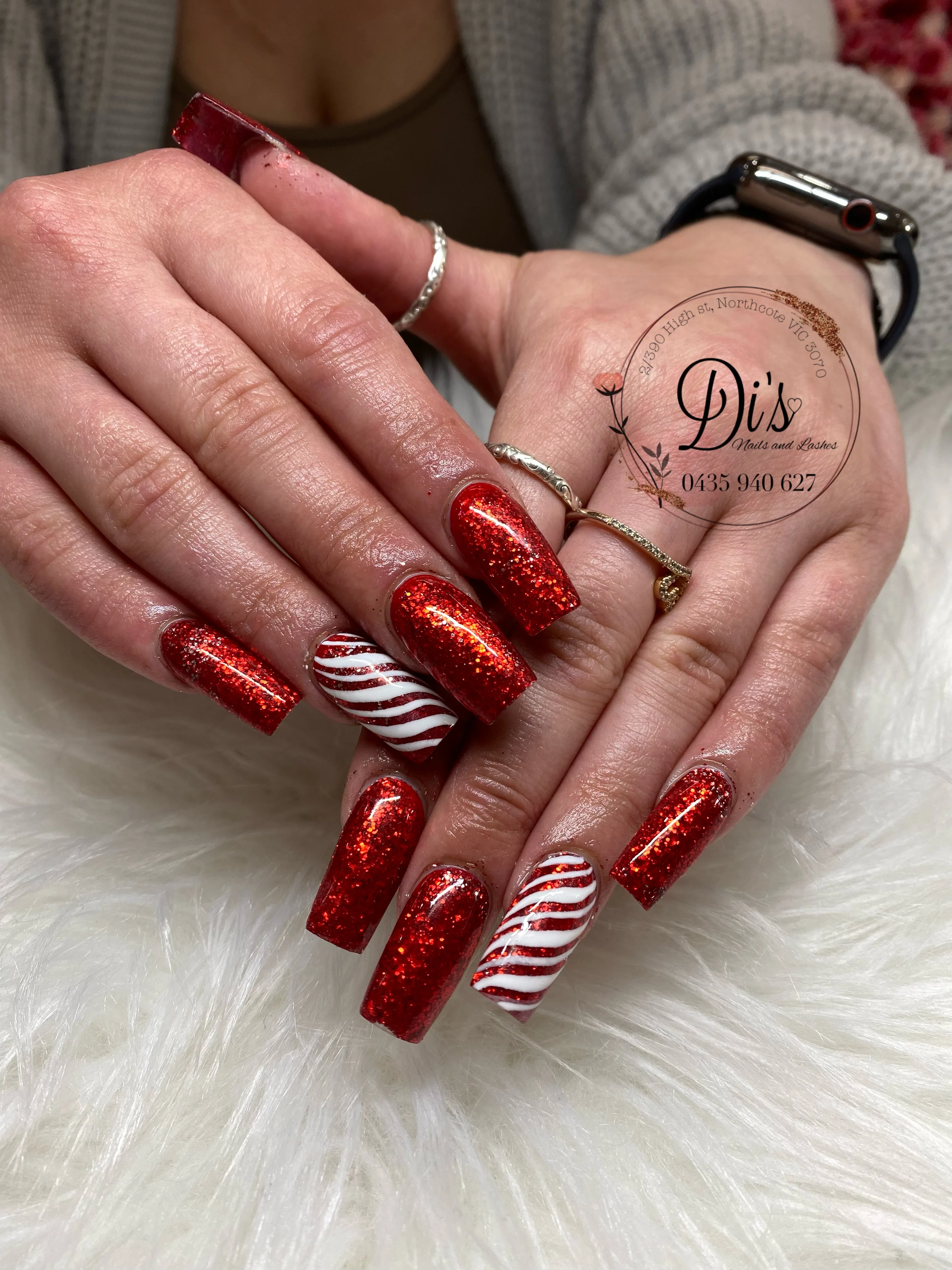 Red glitter candy cane Christmas coffin nail set on white fur