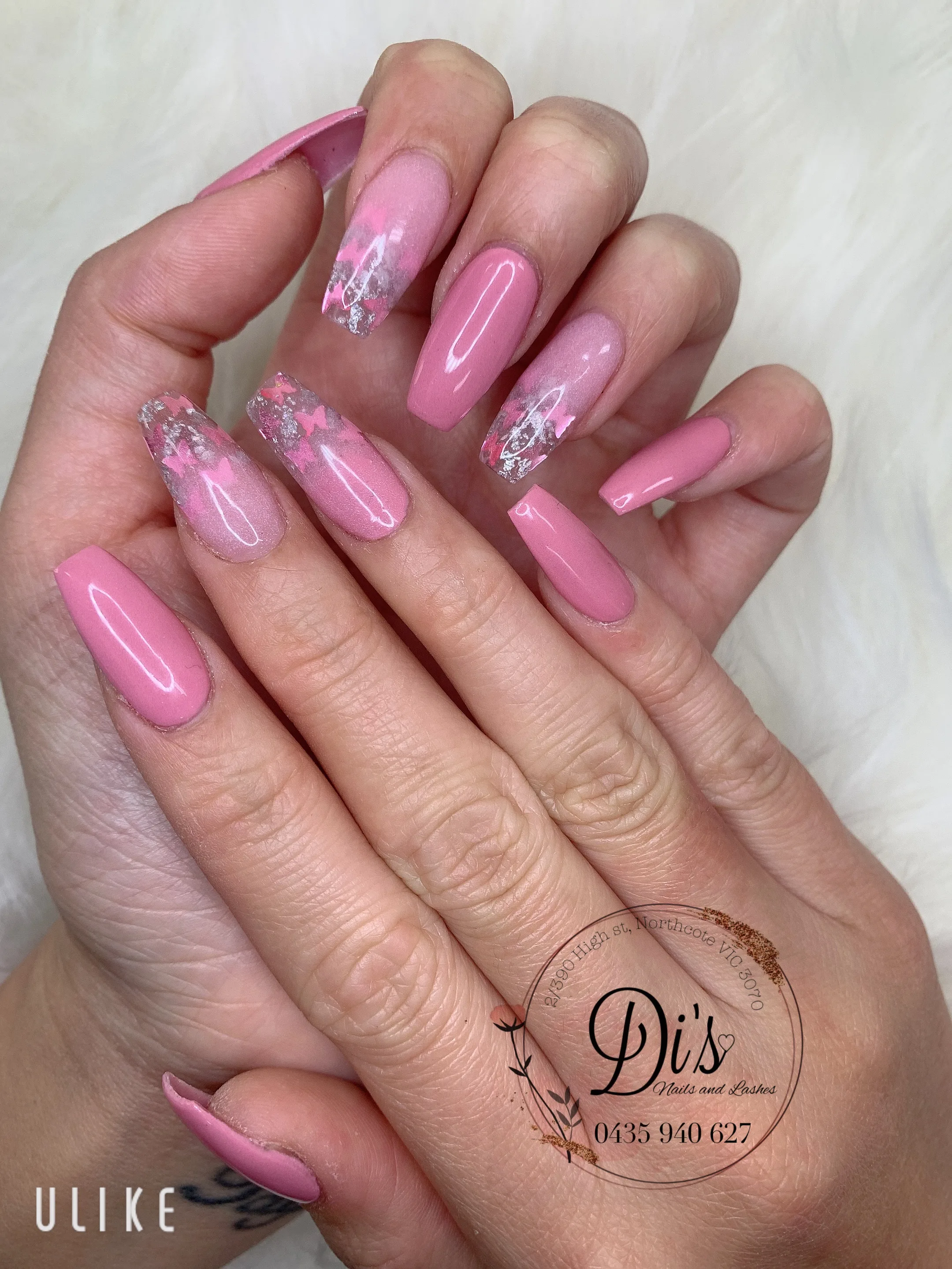 Pink coffin nails with butterfly foil accents on white fur
